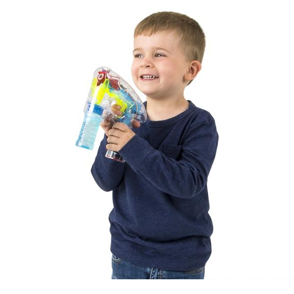 Boy holding bubble gun side view.